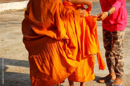  The monk wears a golden yellow robe for a novice robe