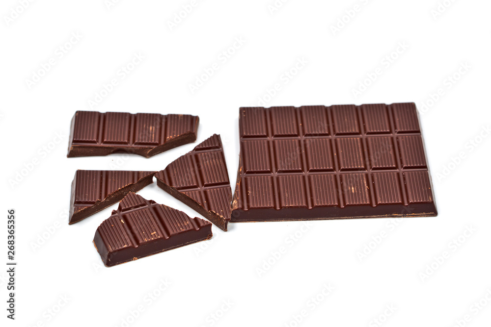 Broken dark chocolate bar isolated on white. Broken dark chocolate bar isolated on white.