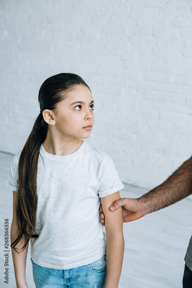 partial view of father grabbing daughter at home partial view of father grabbing daughter at home
