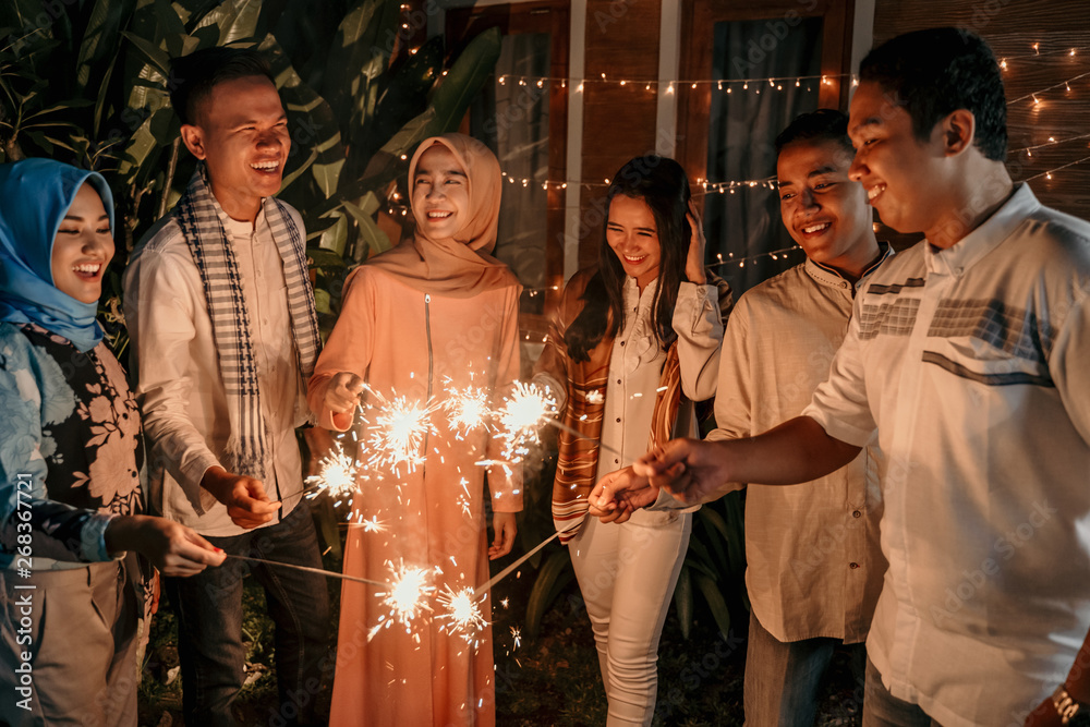 happiness lighting the takbir night fireworks with friends while celebrating the Eid holiday