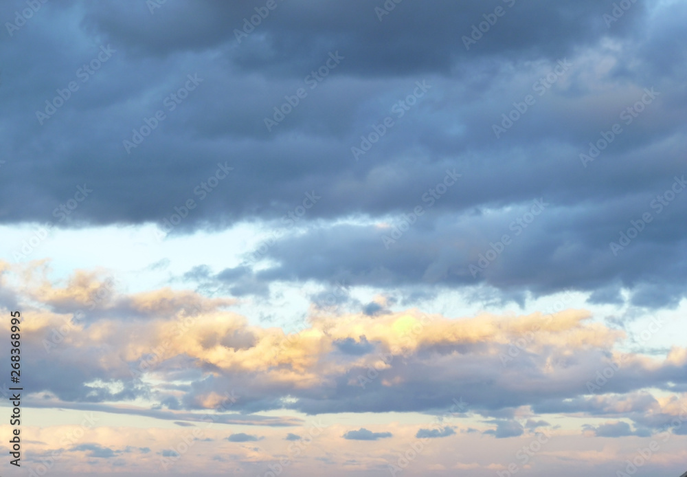 Cloudscape. Beautiful sky. Colorful dramatic sky with clouds at sunset/sunrise. Bright blue, pink, orange and yellow colors of sunset / sunrise. Abstract background. Selective focus