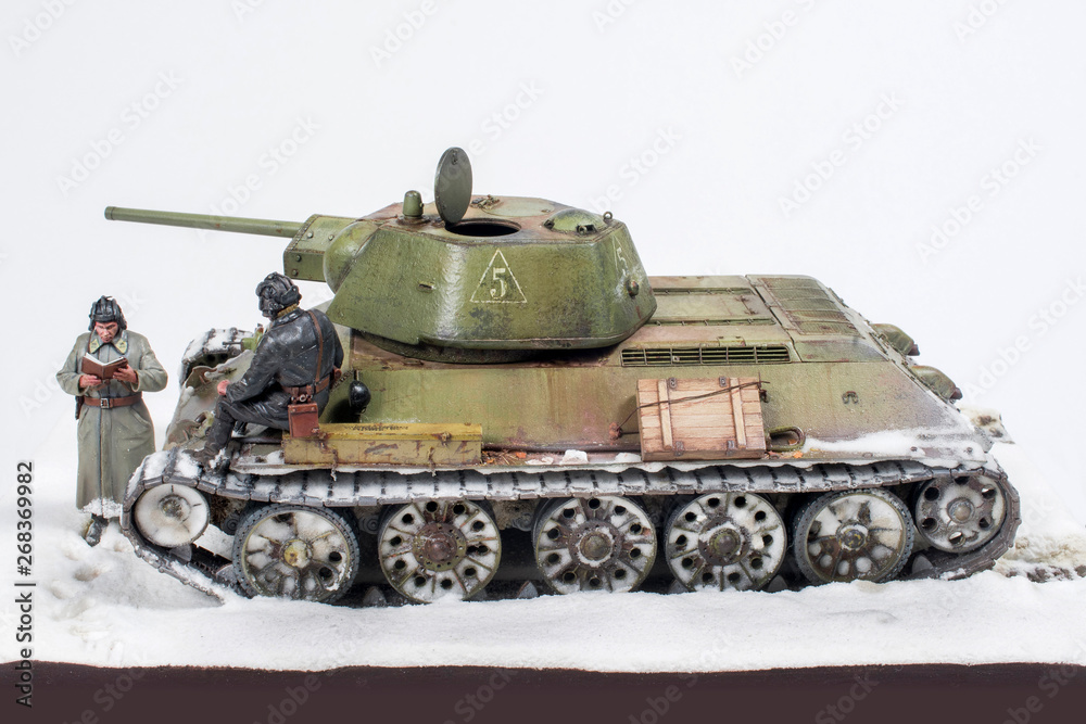 Soviet tank T 34 76 production UVZ, during the Second world war, the crew gets the job. The time period in the winter of 1942. Diorama in modeling, made by the author of the photo.