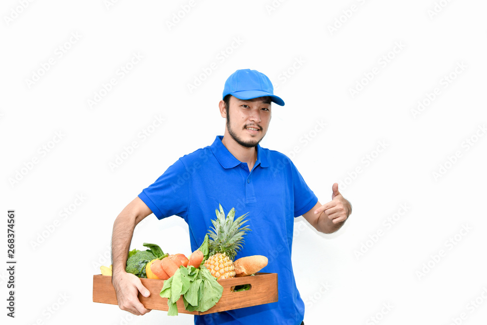 Delivery concept. Delivery guy holding a bag of groceries isolated on white background. Delivery concept. Delivery guy holding a bag of groceries isolated on white background.