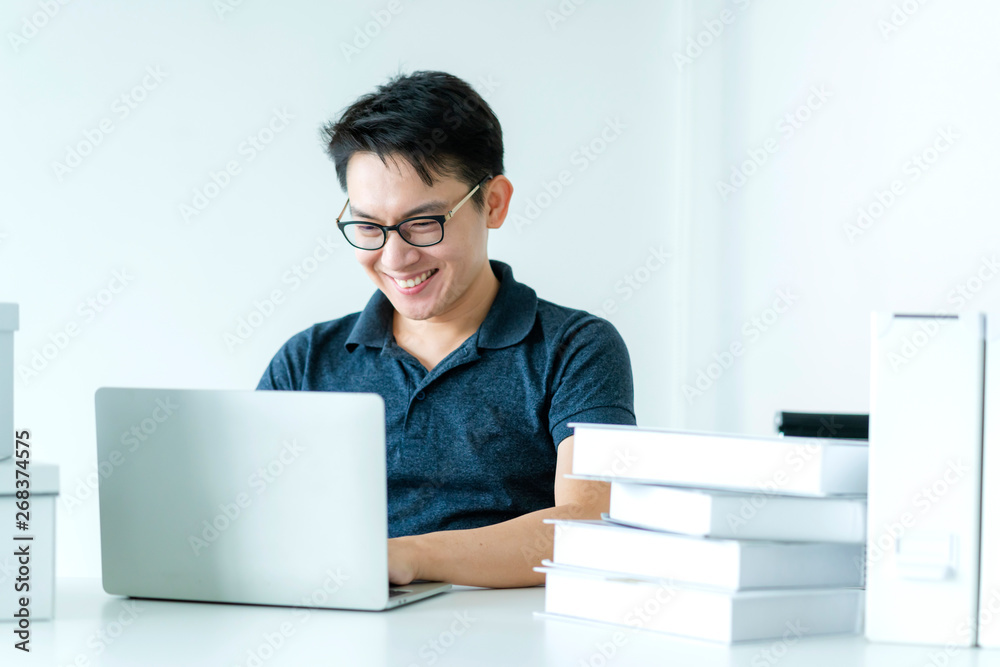 happiness glasses asian man work hand use laptop at home with smile and energy white room background happiness glasses asian man work hand use laptop at home with smile and energy white room background