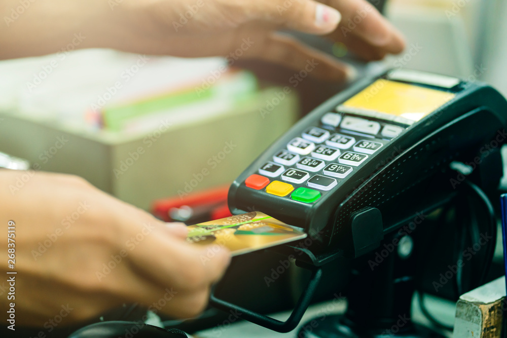 commercial shopping ideas concept with cashier swipe credit card with card reader machine commercial shopping ideas concept with cashier swipe credit card with card reader machine