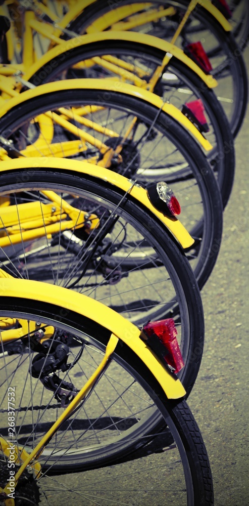 parked yellow bikes of the sharing bike system in the city with parked yellow bikes of the sharing bike system in the city with