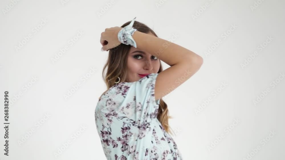 Beautiful smiling girl with long hair laughing on white background. Slow mo Beautiful smiling girl with long hair laughing on white background. Slow mo