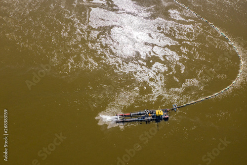 Water pump on the river bank on a big boat. Aerial view