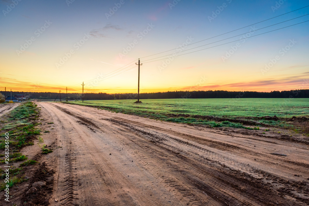 Sunrise over rural meadow field and country open road. Sunrise over rural meadow field and country open road.