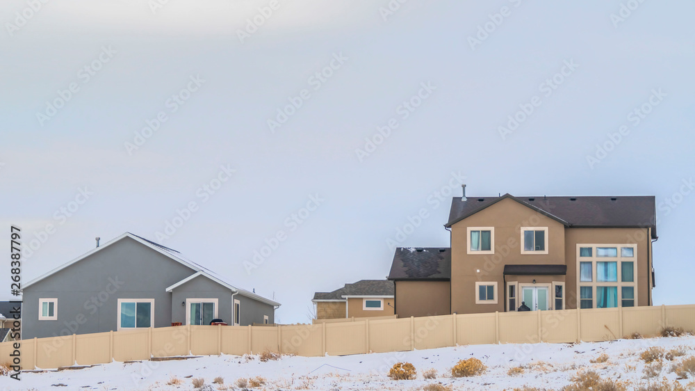 Clear Panorama Facade of houses with a boundless cloudy sky background in winter Clear Panorama Facade of houses with a boundless cloudy sky background in winter