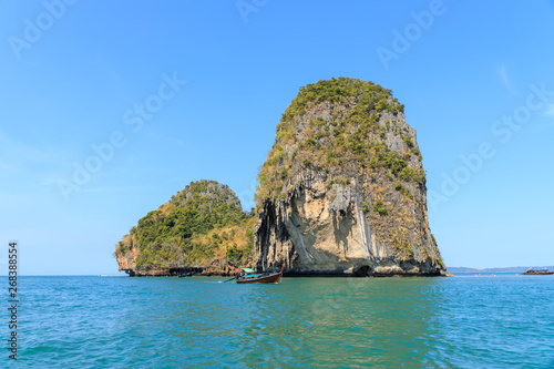 Rang Islands with beautiful clear turquoise blue sea and logn tail boat at Ao Phra Nang near Railay beach, Krabi, Thailand © wirojsid