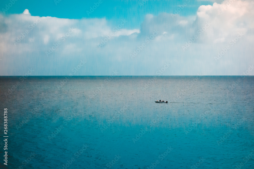 lone boat in the ocean with dramatic sky