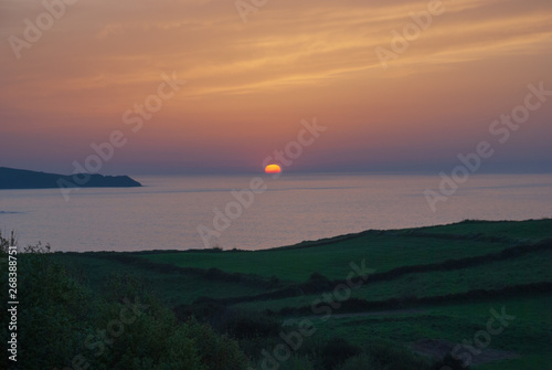 Sunset in the sea with reddish, blue and green tones. On the coast of Cantabria, Spain, Europe