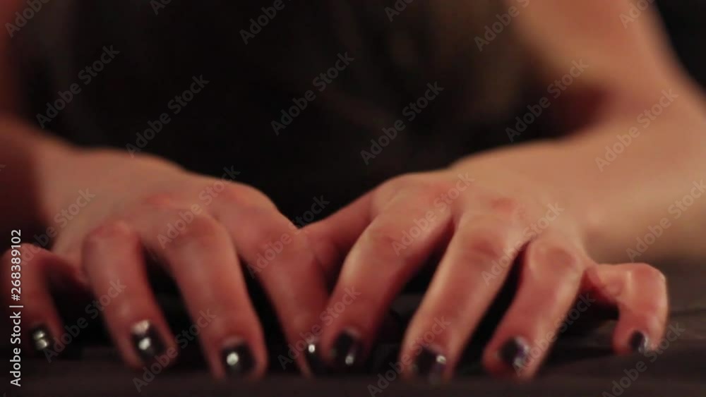 close up of girl's hands clench into fists from pain and pleasure close up of girl's hands clench into fists from pain and pleasure