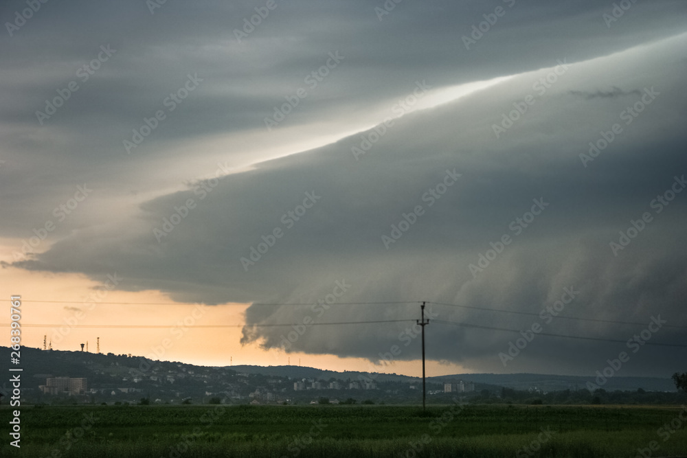 An ominous looking shelf cloud of a severe thunderstorm is approaching the city of Targu Mures in Transylvania, Romania An ominous looking shelf cloud of a severe thunderstorm is approaching the city of Targu Mures in Transylvania, Romania