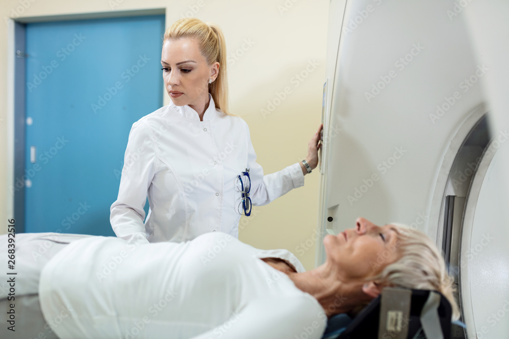 Radiologist supervising patient during MRI scanning procedure. Radiologist supervising patient during MRI scanning procedure.