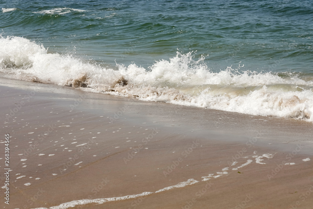Splash of the sea wave on the sandy shore Splash of the sea wave on the sandy shore