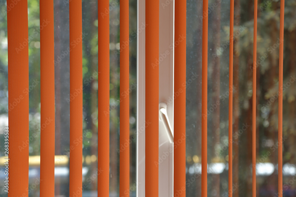 Textured surface of colored vertical textile blinds