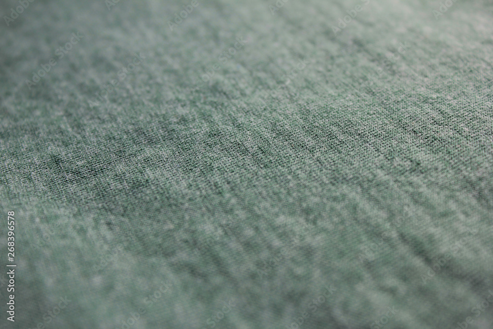 Pale soft green fabric background with selective focus, low angle view of cotton green shirt Pale soft green fabric background with selective focus, low angle view of cotton green shirt