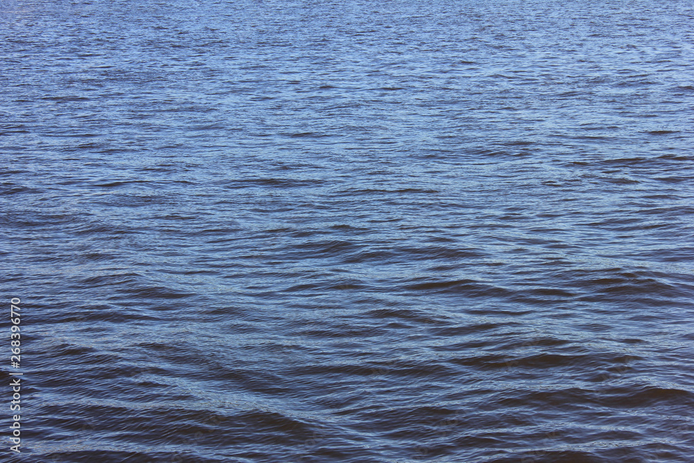 Blue water surface background with small waves 