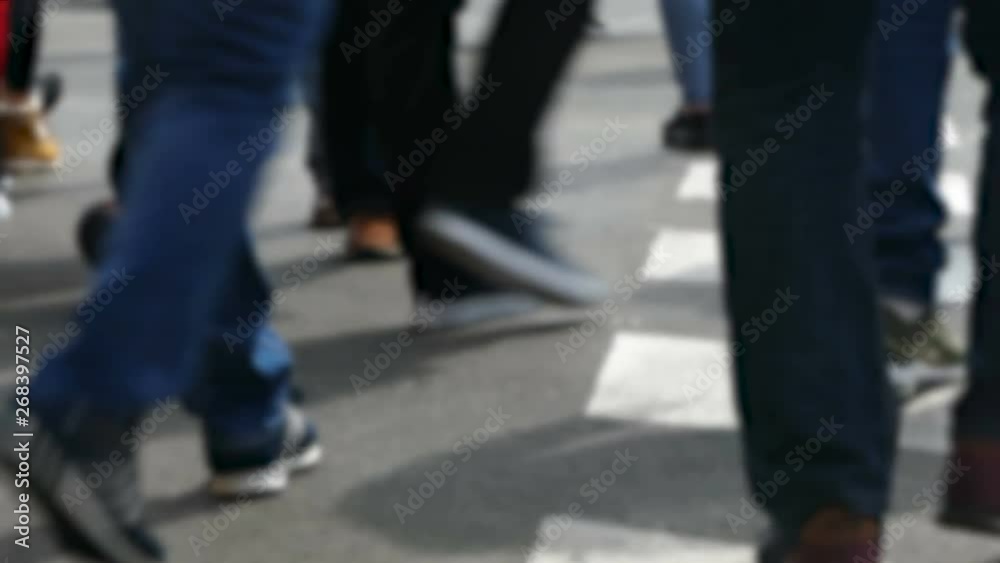 Rear view blurry pedestrians walking. Detail of legs crossing a street in the city of Barcelona. Rear view blurry pedestrians walking. Detail of legs crossing a street in the city of Barcelona.
