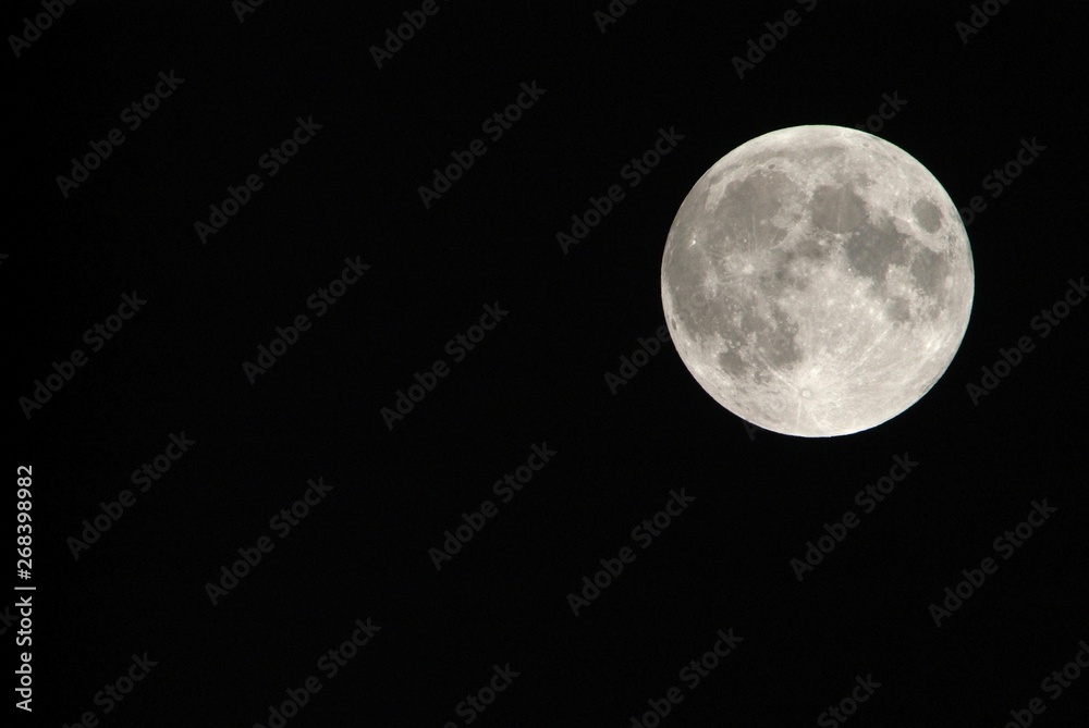 Obraz premium View, of a phase, of the lunar eclipse through a telephoto lens in Turin, Italy
