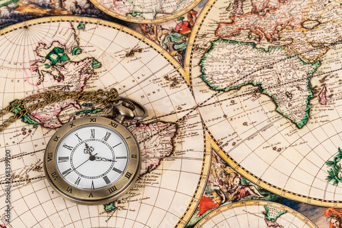 Vintage pocket watch clock on ancient map background