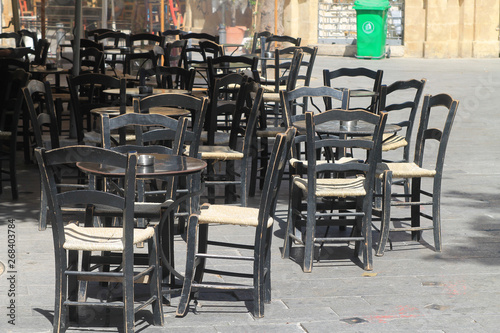 Cafe tables and chairs on the street © Olga