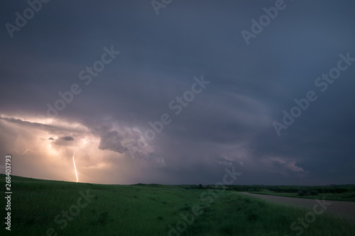 Lightning from a supercell thunderstorm over the northern plains, USA during blue hour.