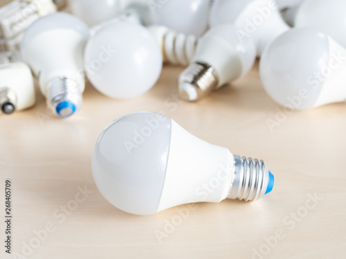 LED bulb light in front of pile from various lamps