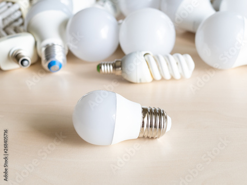 small LED bulb light in front of different lamps