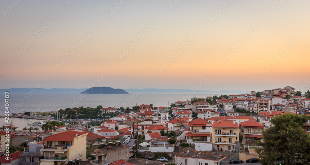Golden hour view of amazing Neos Marmaras cityscape and turtle island in Greece from a nearby vantage point