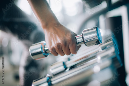 Close up of dumbbells in woman hand