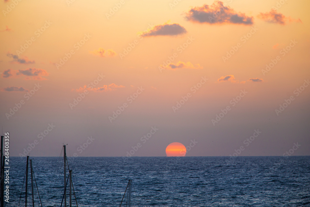 Sunset -   a huge sun goes down in the Mediterranean  sea .Tel Aviv, Israel 