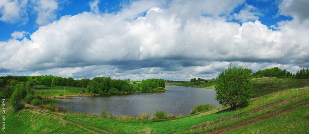 Spring landscape with river and green fields Spring landscape with river and green fields