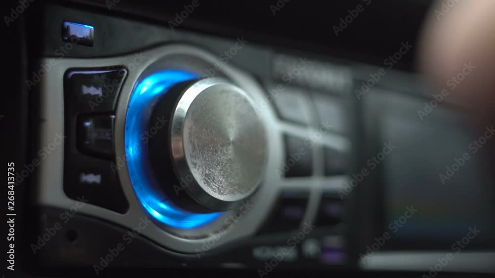 Man's Hand Tuning Radio In The Car Man's Hand Tuning Radio In The Car