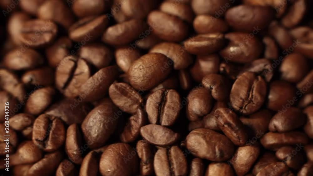 Beans of Coffee Raining at Slow Motion. Morning black coffee texture. Coffee beans factory mixing, close up. Roasted coffee bean. Beans of Coffee Raining at Slow Motion. Morning black coffee texture. Coffee beans factory mixing, close up. Roasted coffee bean.