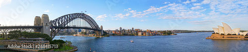Panoramic view of Sydney harbor bridge and North Sydney, boats sailing in the bay and Parramatta River. Evening Light