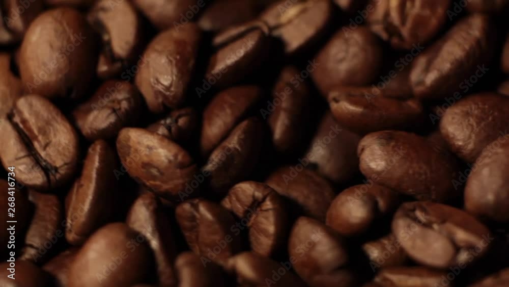 Coffee beans. Close up of seeds of coffee. Beautiful seeds of coffee. Dark Coffee Grains. Rotating and falling Coffee beans. Close up of seeds of coffee. Beautiful seeds of coffee. Dark Coffee Grains. Rotating and falling