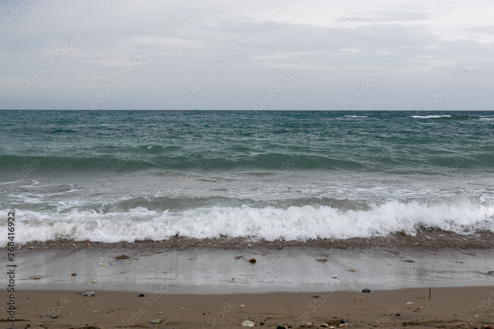 waves and wind on the sea beach with dramatic sky waves and wind on the sea beach with dramatic sky