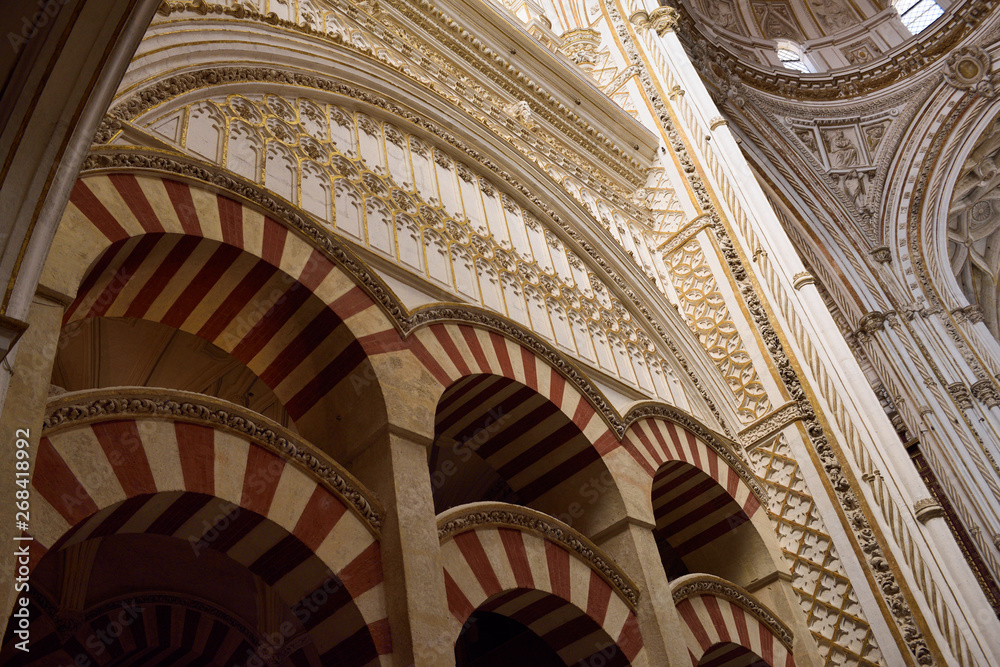 Double red and white arches of the Prayer Hall looking up to the main altar dome in the Cordoba Cathedral Mosque
