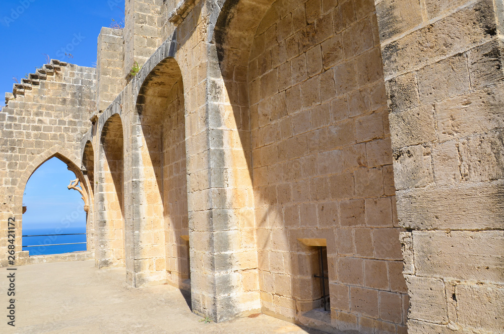 Walls of historical Bellapais Abbey with window overlooking the Mediterranean sea. The beautiful monastery is located in the Turkish part of Cyprus