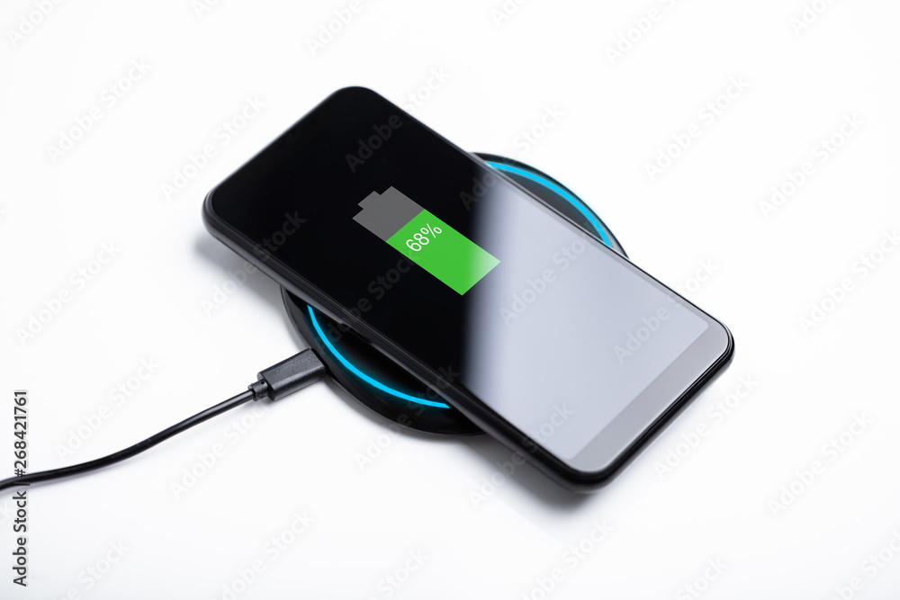 Wireless Charging Pad And Smartphone On Desk Wireless Charging Pad And Smartphone On Desk