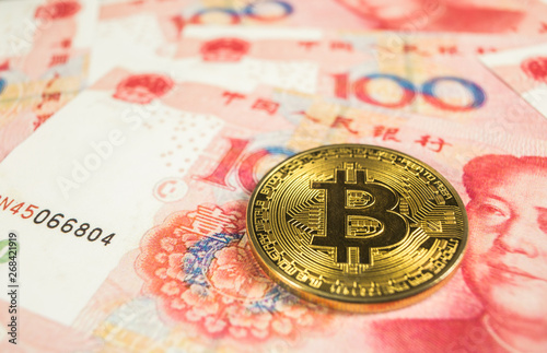 Crypto currency concept - A Bitcoin with Chinece currency RMB, Renminbi, yuan photo