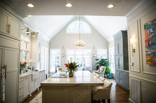 Open Concept Elegant and Spacious Kitchen with Marble Countertops, Chandelier, and Two Toned Cabinets © Ursula Page