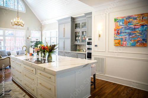 Open Concept Elegant and Spacious Kitchen with Marble Countertops  Chandelier  and Two Toned Cabinets