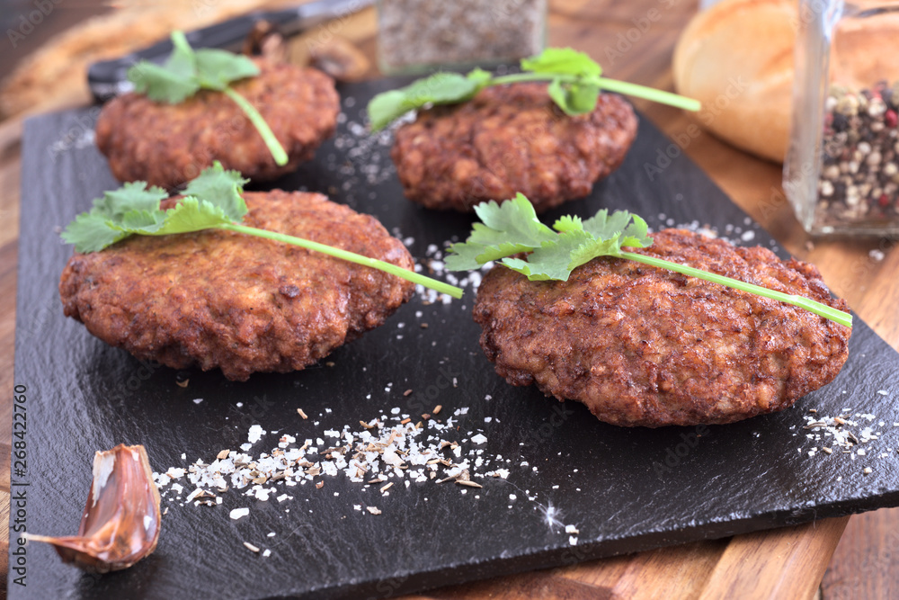 handmade burgers on black stone