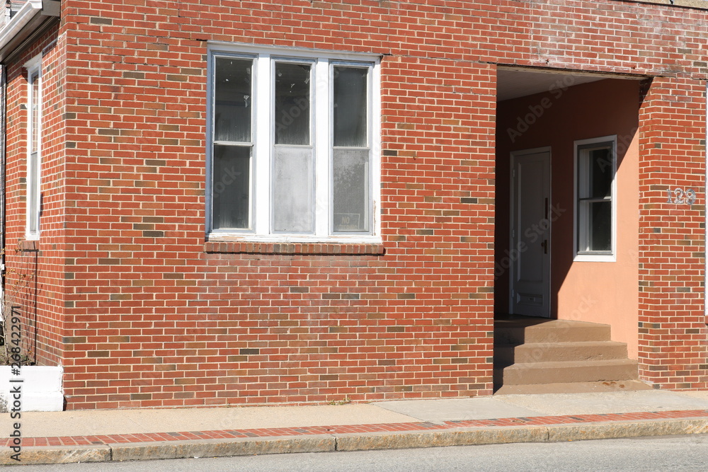 Vacant abandoned brick retail storefront in urban neighborhood Vacant abandoned brick retail storefront in urban neighborhood