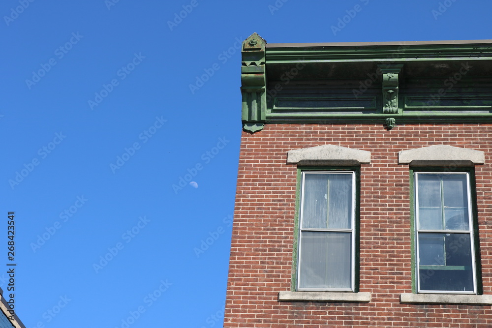 Brick apartment building with ornate detail in urban neighborhood Brick apartment building with ornate detail in urban neighborhood