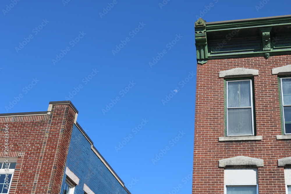 Brick apartment building with ornate detail in urban neighborhood 
